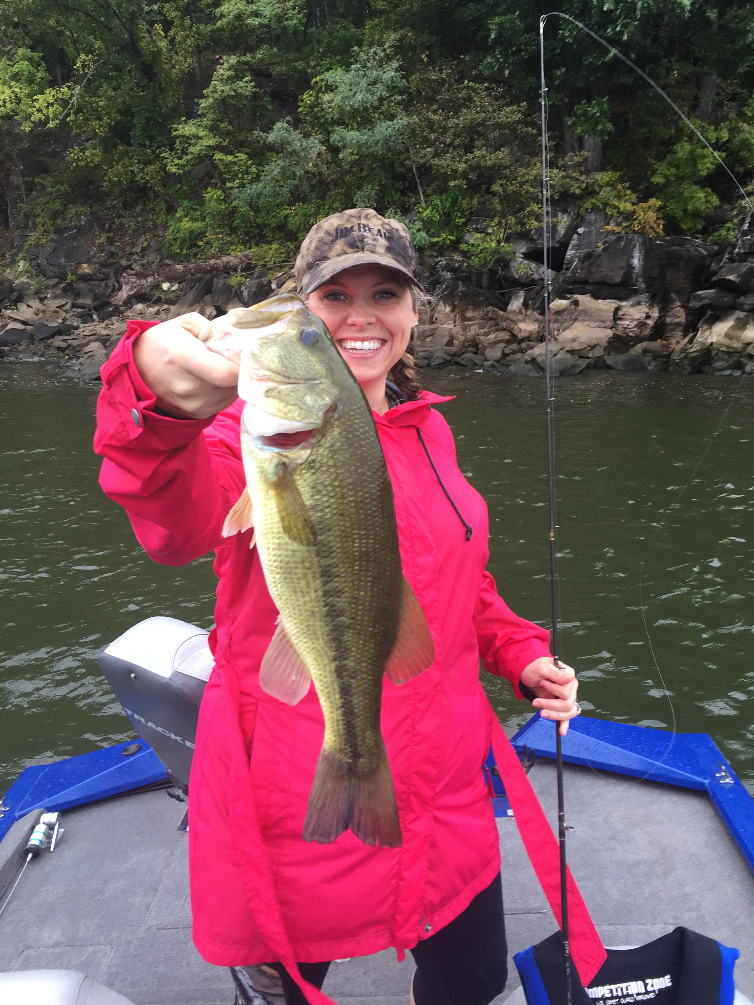 Woman holding up a large bass