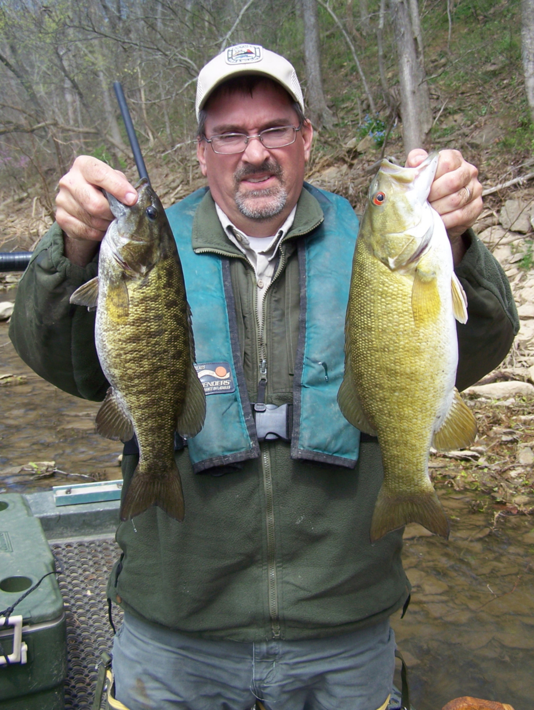 Biologist Jeff Crosby holds two smallmouth bass fished Elkhorn Creek