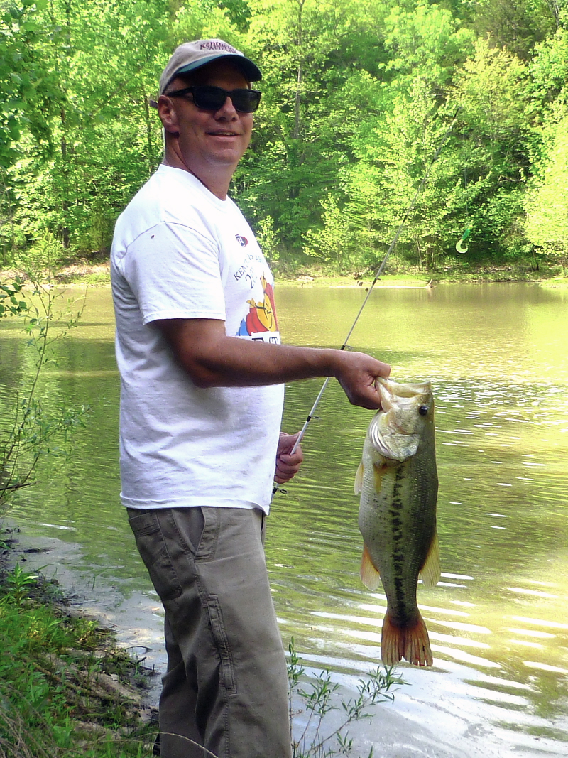 Tim Slone holds a largemouth caught from a pond in Shelby County